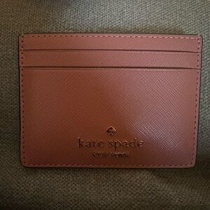 kate spade pink leather card case with gold logo